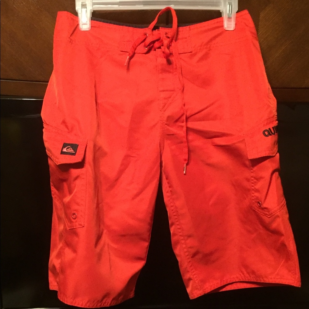 Quicksilver red board shorts. Size 28.